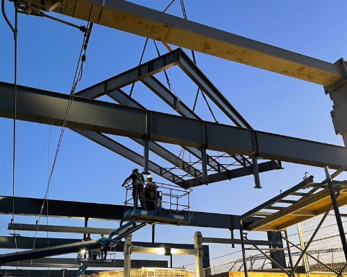 Metal beams being moved